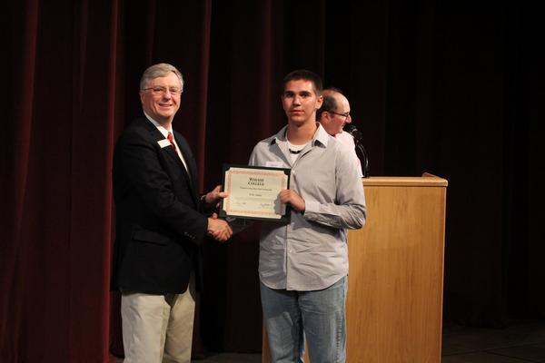 a man holding a certificate