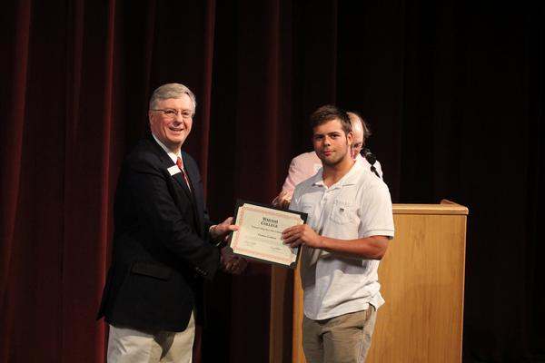 a man holding a certificate