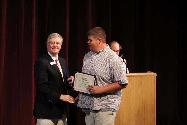 a man holding a certificate