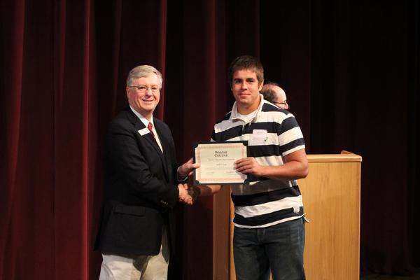 a man holding a certificate