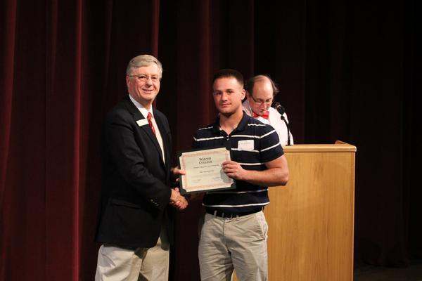 a man holding a certificate