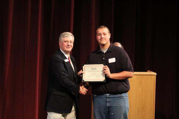 a man holding a certificate