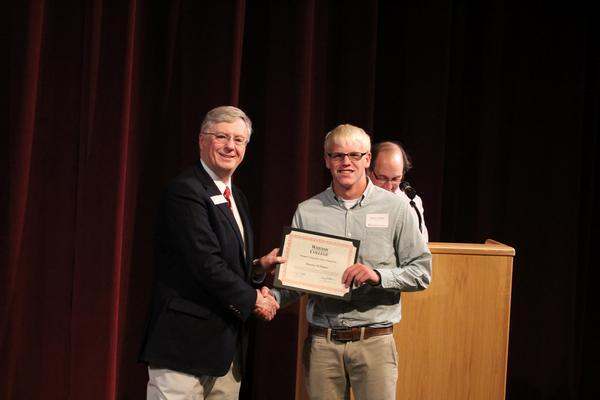 a man holding a certificate