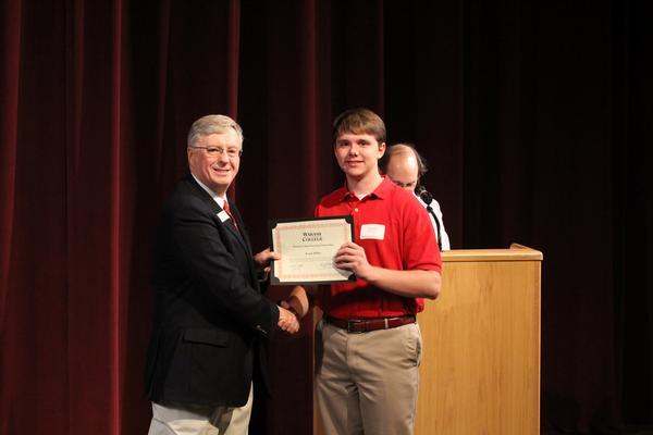 a man holding a certificate