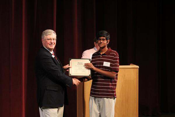 a man holding a certificate