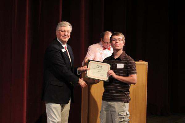 a man holding a certificate