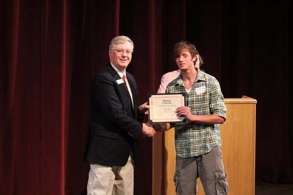 a man holding a certificate
