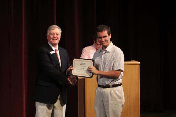 a man holding a certificate