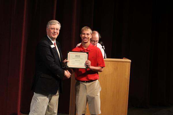 a man holding a certificate