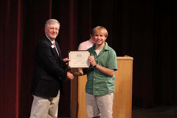 a man holding a certificate