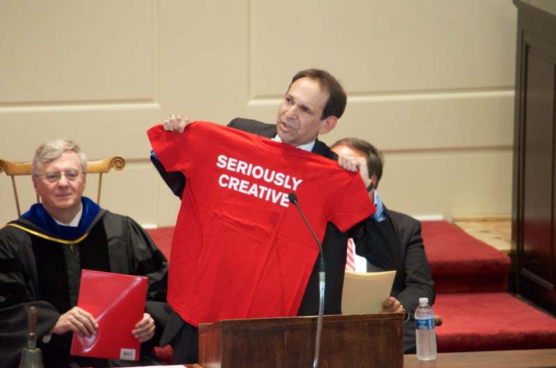 a man holding a red shirt