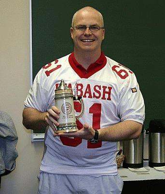 a man holding a trophy
