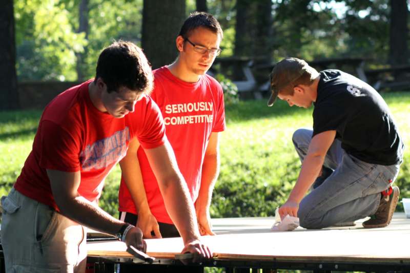 a group of men working on a table