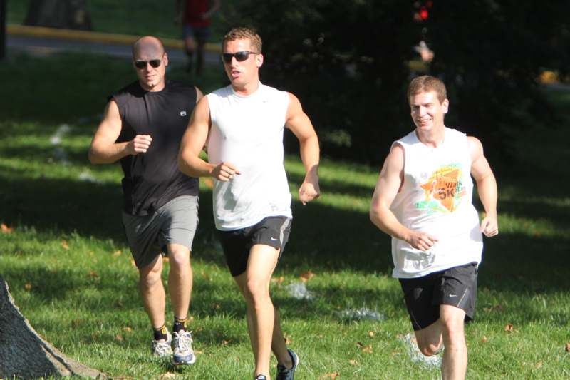 a group of men running on grass