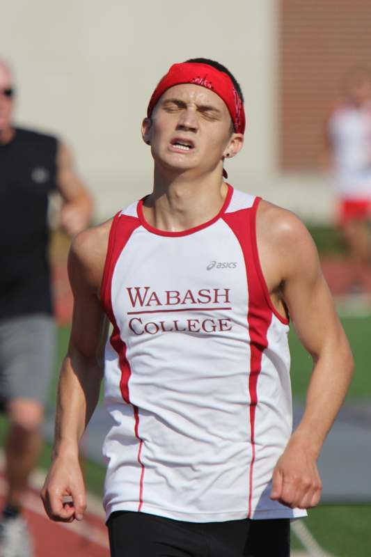 a man wearing a red headband and running