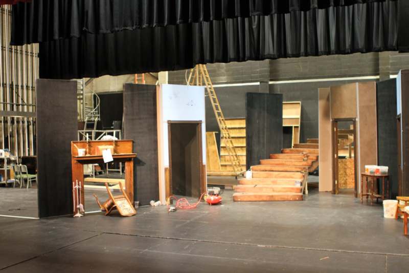 a stage with stairs and stairs and a stage with a black curtain