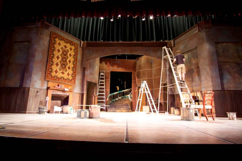 a man on a ladder in a stage