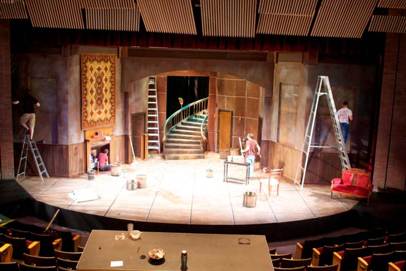 a stage with a staircase and a man on it