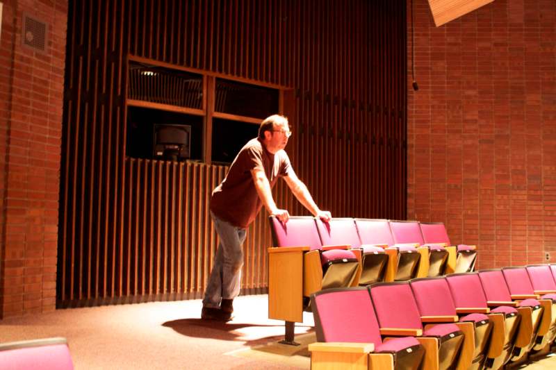 a man standing in a auditorium
