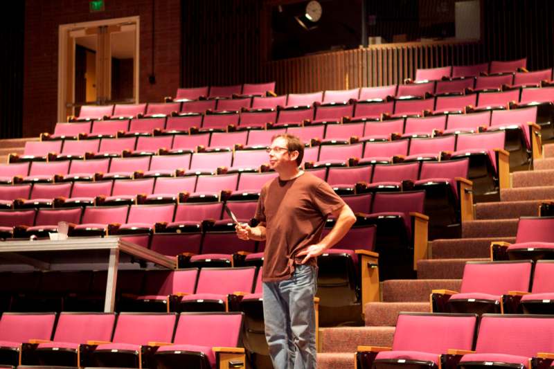 a man standing in a auditorium