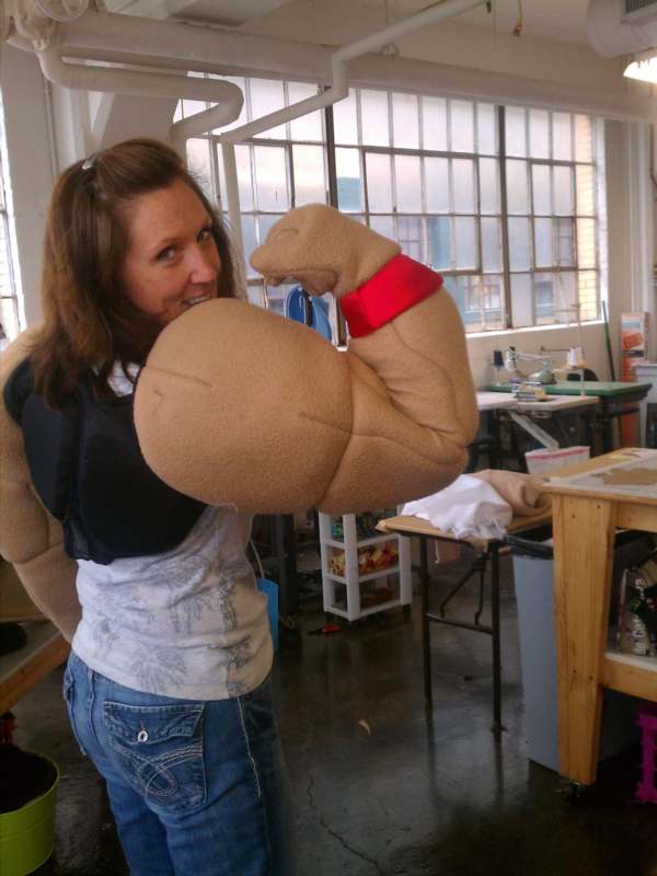 a woman wearing a large stuffed arm