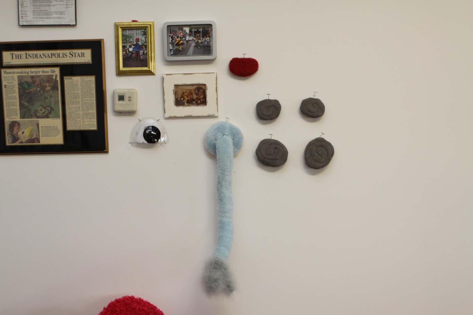 a wall with pictures and objects on it