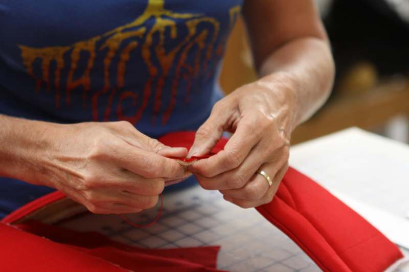 a close-up of a woman sewing