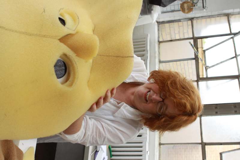 a woman holding a yellow stuffed animal
