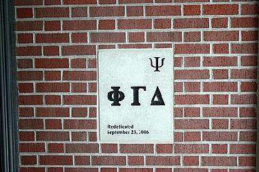 a white sign on a brick wall
