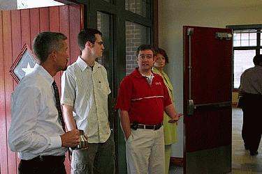 a group of people standing in a hallway