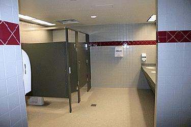a man standing in a public bathroom