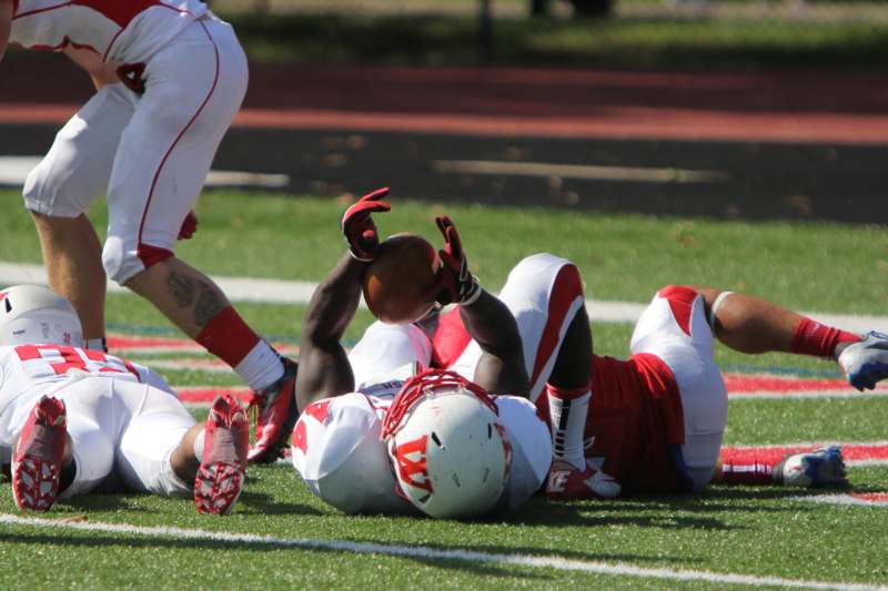a football player lying on the ground with a football
