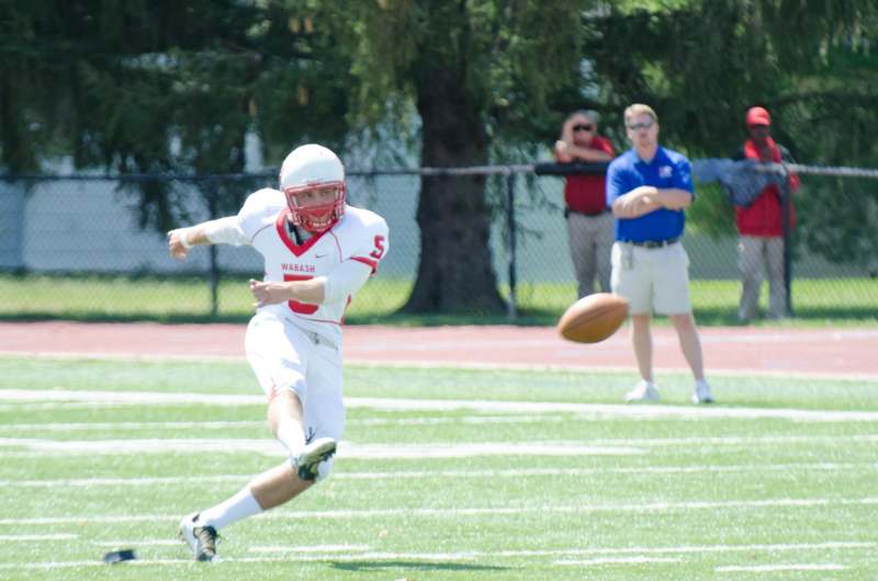 a man in a football uniform running with a football