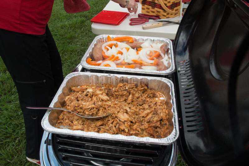 food in foil trays on a grill