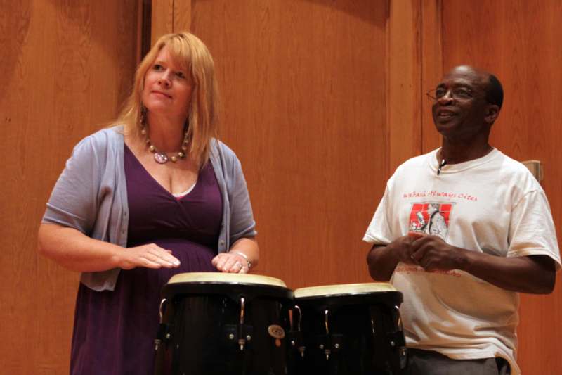 a man and woman playing drums
