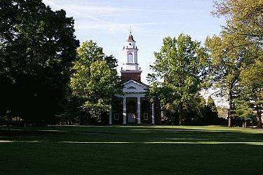 a building with a tower and trees