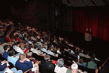 a man giving a presentation in a lecture hall