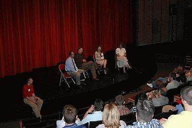 a group of people sitting on a stage