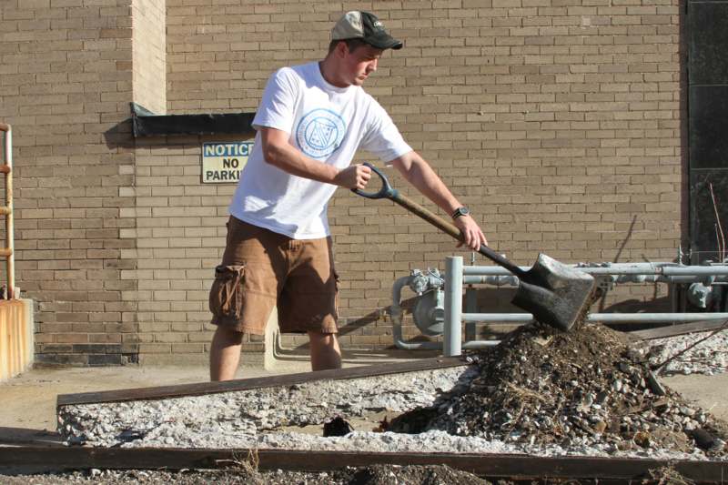 a man digging a pile of dirt