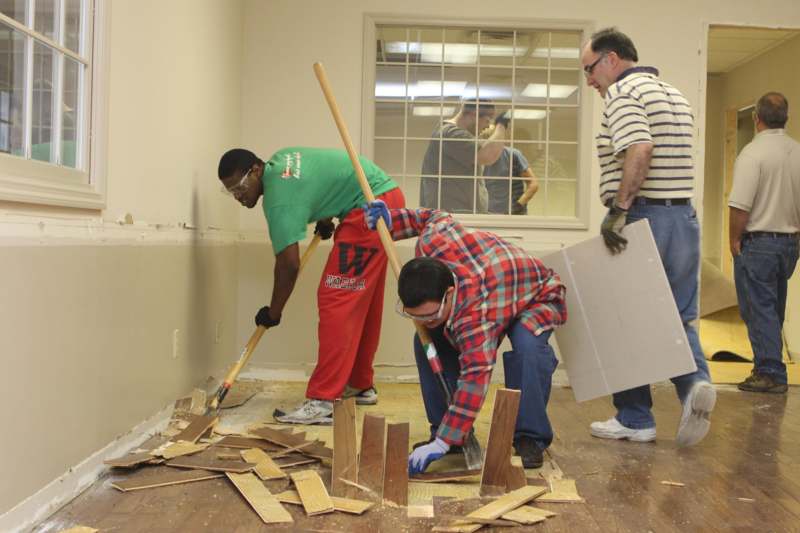 a group of men working on a floor