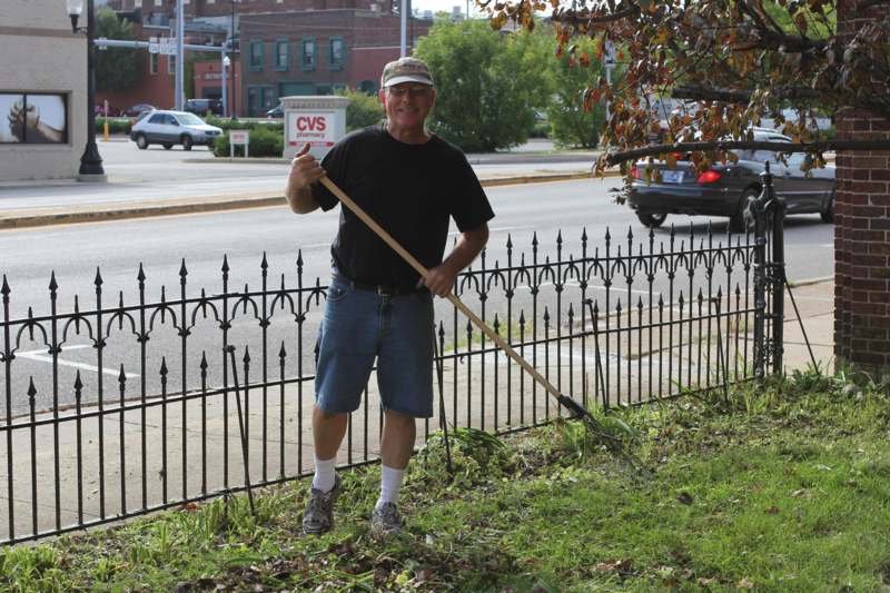 a man holding a rake