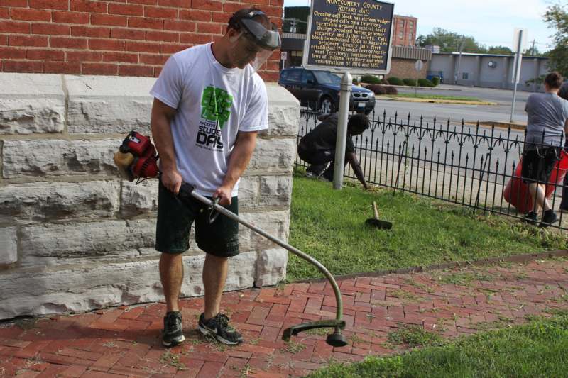 a man holding a lawn mower