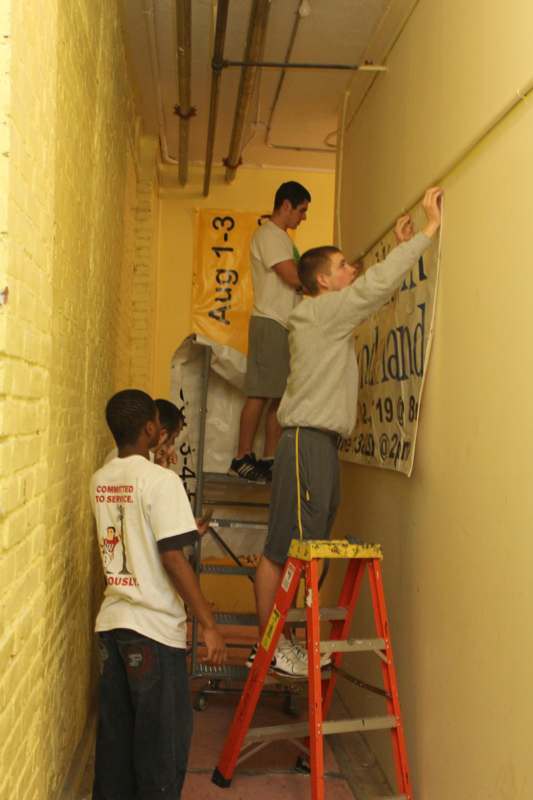 a group of young men working on a wall
