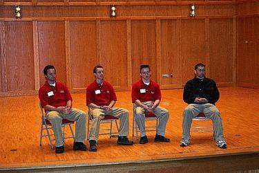 a group of men sitting on a stage