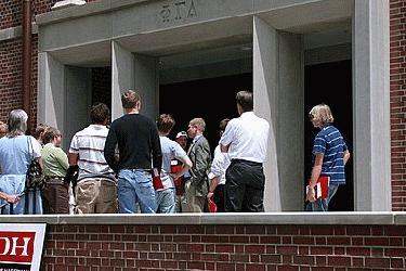 a group of people standing outside of a building