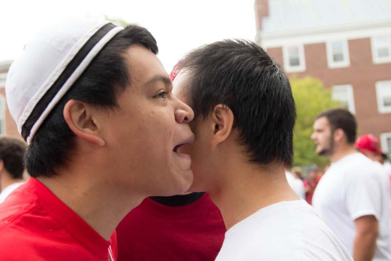 a man kissing another man's face