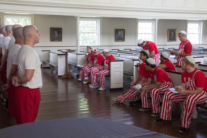 a group of men in red and white striped pants