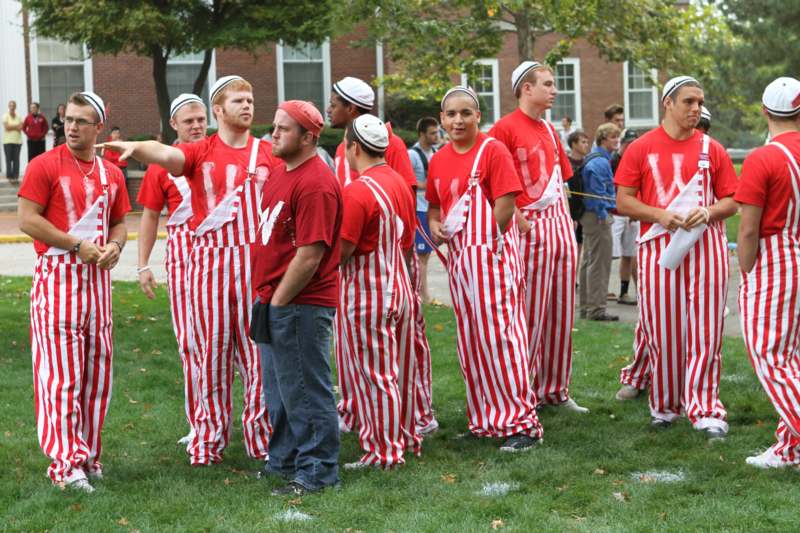 a group of people wearing striped overalls