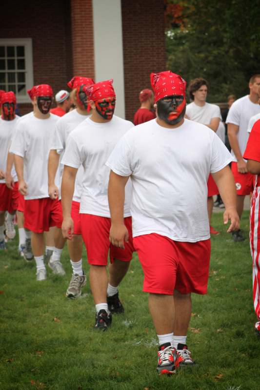 a group of people wearing red and white shirts and black face paint