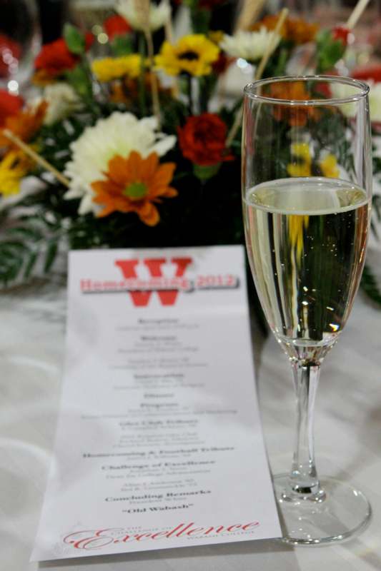 a glass of champagne next to a menu